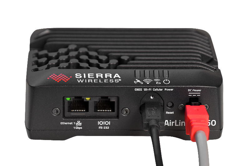 A black box with red and white cables Description automatically generated